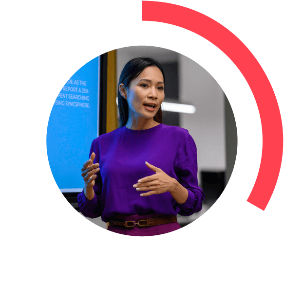 woman wearing a purple shirt and giving a lecture