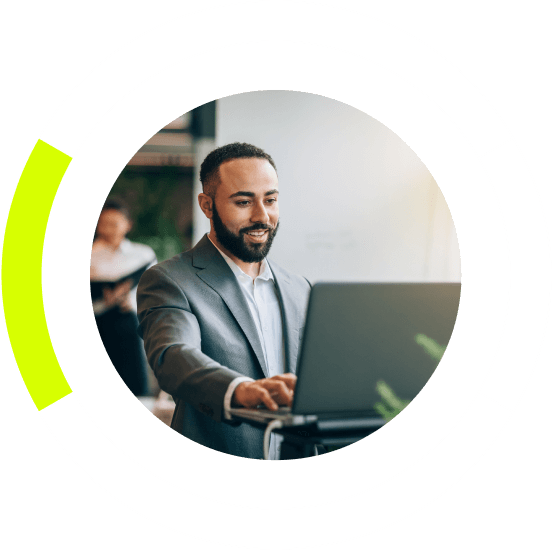 man smiling working on a laptop